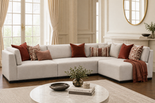 Load image into Gallery viewer, Luxury bespoke Amcross corner sofa with timber plinth in a modern London living room